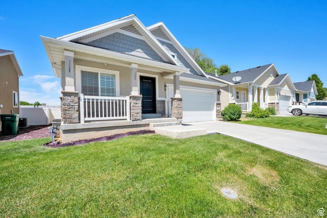 257 N 1125 W, Clearfield, UT 84015 - craftsman house with stone siding, a porch, a garage, a front yard, and concrete driveway