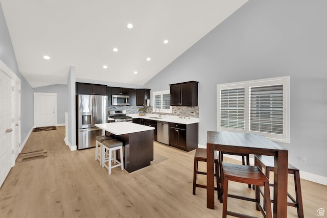 257 N 1125 W, Clearfield, UT 84015 - kitchen with appliances with stainless steel finishes, a sink, a center island, light countertops, and light wood-type flooring