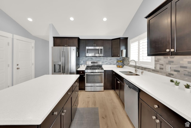 257 N 1125 W, Clearfield, UT 84015 - kitchen featuring stainless steel appliances, lofted ceiling, light wood-style flooring, dark brown cabinets, and a sink