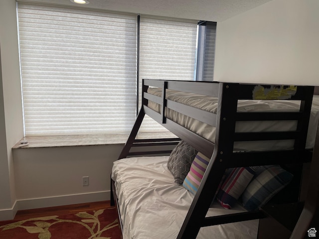 44 W 300 S Unit 1107N, Salt Lake City, UT 84101 - bedroom featuring baseboards and wood finished floors