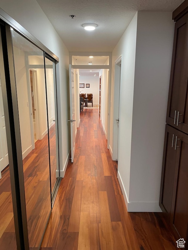 44 W 300 S Unit 1107N, Salt Lake City, UT 84101 - hallway featuring dark wood-type flooring and baseboards