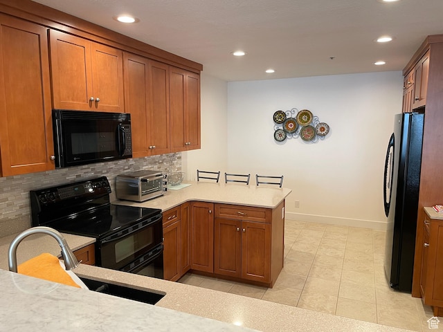 44 W 300 S Unit 1107N, Salt Lake City, UT 84101 - kitchen featuring black appliances, decorative backsplash, recessed lighting, brown cabinetry, and a peninsula