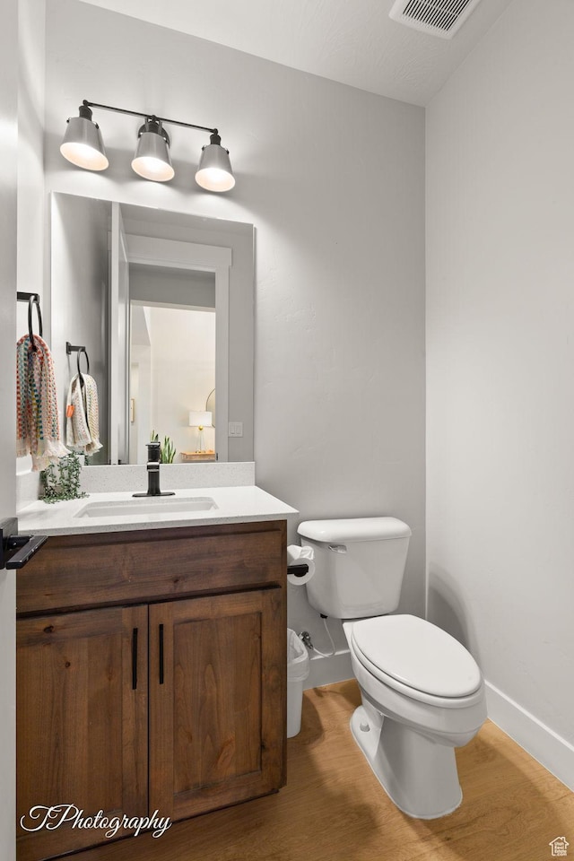 3134 E Blue Heron Dr S, St George, UT 84790 - half bath with toilet, baseboards, wood finished floors, and vanity