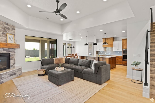 3134 E Blue Heron Dr S, St George, UT 84790 - living area with stairs, a ceiling fan, light wood-style floors, recessed lighting, and a fireplace