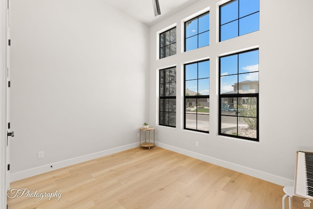 3134 E Blue Heron Dr S, St George, UT 84790 - unfurnished room featuring wood finished floors, baseboards, and a towering ceiling