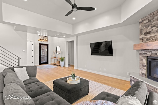 3134 E Blue Heron Dr S, St George, UT 84790 - living area with stairs, wood finished floors, baseboards, a stone fireplace, and recessed lighting