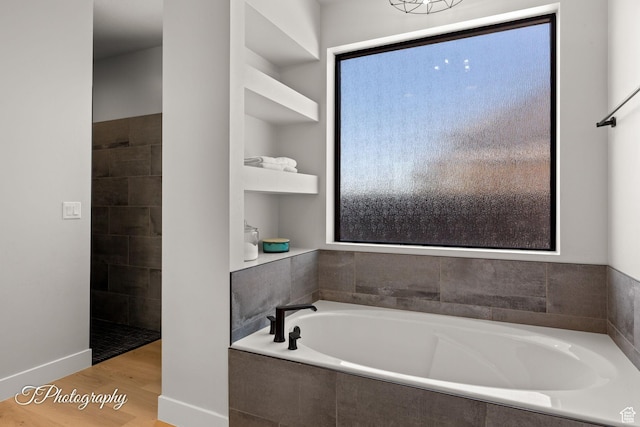 3134 E Blue Heron Dr S, St George, UT 84790 - bathroom featuring a garden tub and wood finished floors