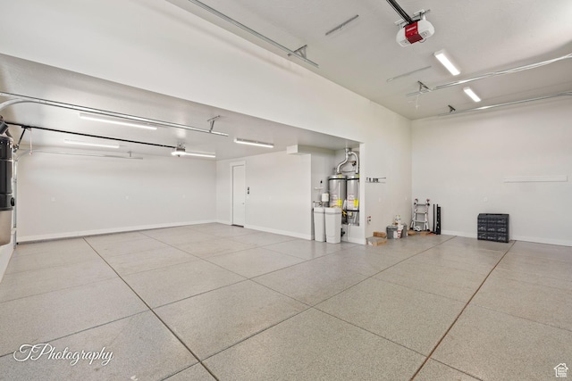 3134 E Blue Heron Dr S, St George, UT 84790 - garage featuring a garage door opener, baseboards, and secured water heater