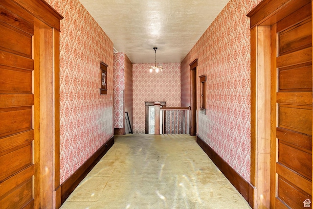 157 N 500 W, Logan, UT 84321 - hall with wallpapered walls, an upstairs landing, a chandelier, and carpet floors