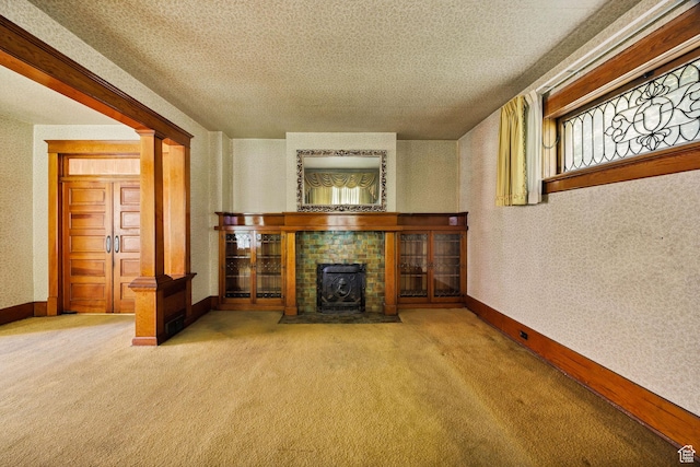 157 N 500 W, Logan, UT 84321 - unfurnished living room with carpet flooring, baseboards, a textured ceiling, and decorative columns