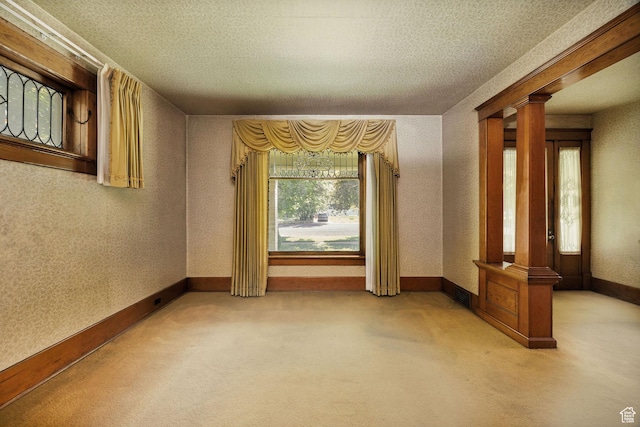 157 N 500 W, Logan, UT 84321 - spare room featuring ornate columns, carpet flooring, a textured ceiling, and baseboards