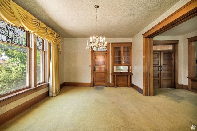 157 N 500 W, Logan, UT 84321 - dining area with light carpet, a chandelier, baseboards, and a textured ceiling