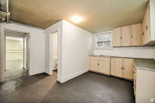 157 N 500 W, Logan, UT 84321 - kitchen featuring finished concrete flooring, baseboards, and a sink