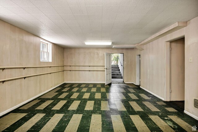 157 N 500 W, Logan, UT 84321 - below grade area featuring tile patterned floors, stairway, wooden walls, plenty of natural light, and baseboards