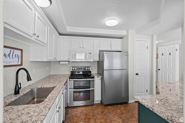 79 W 1970 N, Tooele, UT 84074 - kitchen featuring appliances with stainless steel finishes, a sink, white cabinets, and light stone counters