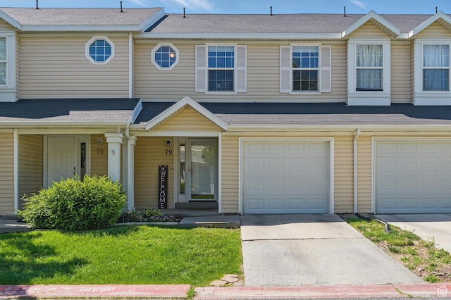 79 W 1970 N, Tooele, UT 84074 - townhome / multi-family property with driveway, a garage, covered porch, and a front lawn