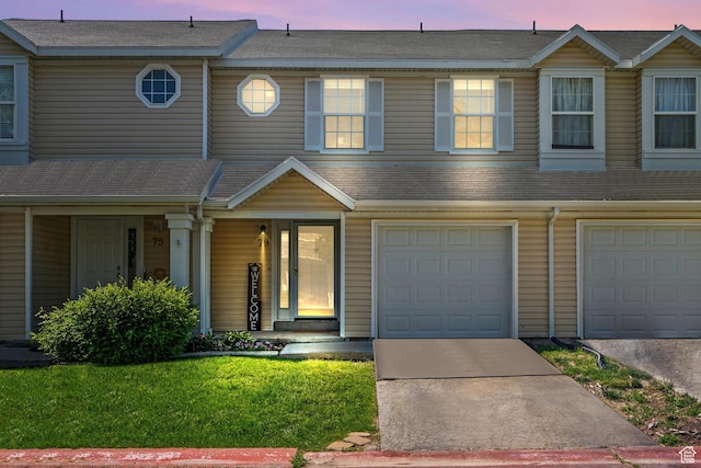 79 W 1970 N, Tooele, UT 84074 - townhome / multi-family property featuring a porch, driveway, an attached garage, and a front lawn
