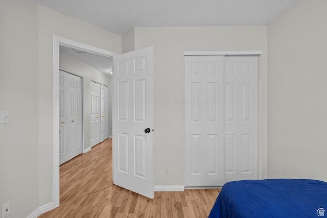 79 W 1970 N, Tooele, UT 84074 - bedroom with light wood-style floors, baseboards, and two closets