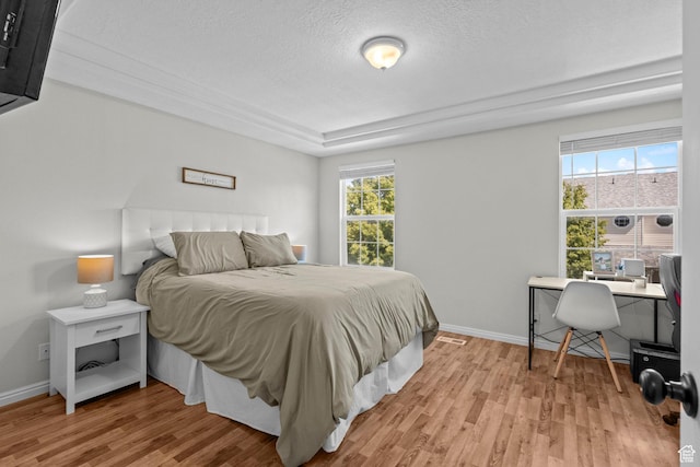 79 W 1970 N, Tooele, UT 84074 - bedroom featuring light wood-type flooring, a textured ceiling, an office area, baseboards, and a tray ceiling