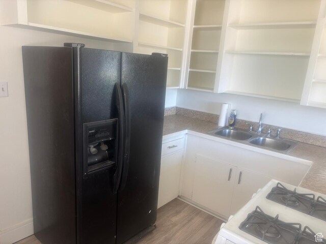4575 W 4925 S, Kearns, UT 84118 - kitchen featuring black refrigerator with ice dispenser, open shelves, a sink, white range with gas stovetop, and light wood-type flooring