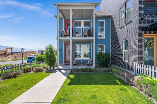 5087 W Rambutan Way S, Jordan, UT 84009 - view of front of house featuring a mountain view, stucco siding, and a balcony