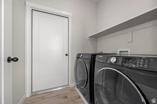 5087 W Rambutan Way S, Jordan, UT 84009 - laundry room with washing machine and dryer, light wood-style flooring, and baseboards