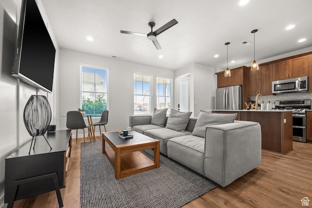 5087 W Rambutan Way S, Jordan, UT 84009 - living room with a ceiling fan, recessed lighting, and light wood-style floors