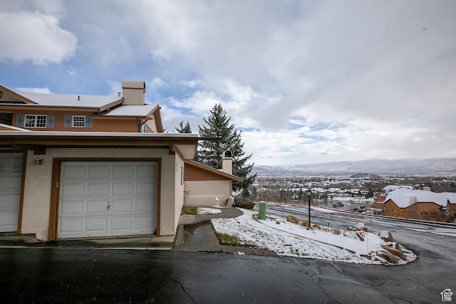 874 W Schneitter Cir Unit 7, Midway, UT 84049 - view of snow covered exterior with a chimney, stucco siding, and a mountain view