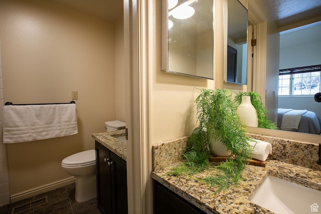 874 W Schneitter Cir Unit 7, Midway, UT 84049 - ensuite bathroom featuring vanity, toilet, and baseboards