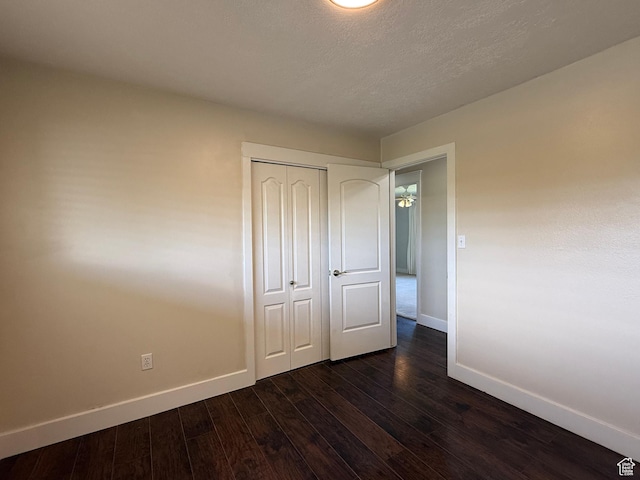 737 S 400 E, Payson, UT 84651 - unfurnished bedroom featuring baseboards, dark wood finished floors, a closet, and a textured ceiling