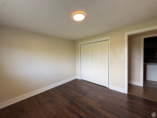737 S 400 E, Payson, UT 84651 - unfurnished bedroom with baseboards, dark wood-type flooring, and a closet