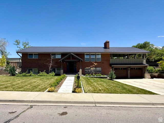 737 S 400 E, Payson, UT 84651 - bi-level home featuring a chimney, an attached garage, a front yard, driveway, and metal roof