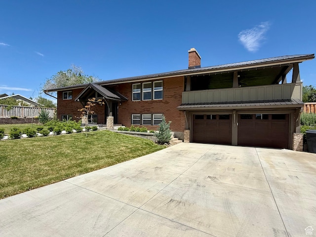 737 S 400 E, Payson, UT 84651 - bi-level home featuring an attached garage, a chimney, concrete driveway, metal roof, and stone siding