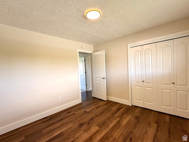 737 S 400 E, Payson, UT 84651 - unfurnished bedroom with baseboards, dark wood-style floors, a closet, and a textured ceiling