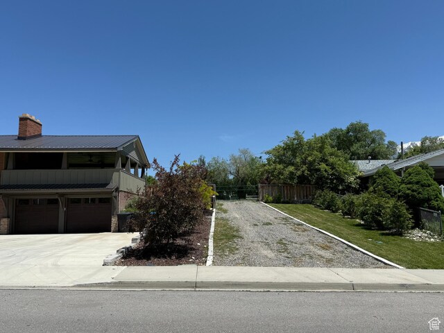 737 S 400 E, Payson, UT 84651 - view of front of property with driveway, a garage, a balcony, a chimney, and metal roof