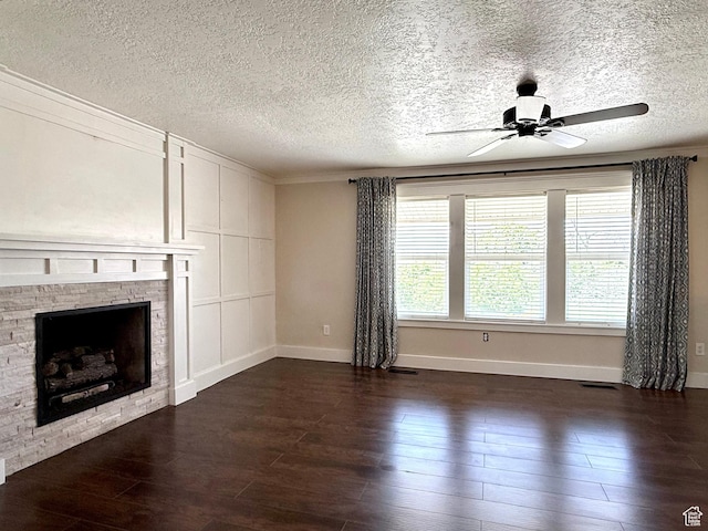 737 S 400 E, Payson, UT 84651 - unfurnished living room featuring baseboards, dark wood-type flooring, ceiling fan, a textured ceiling, and a fireplace