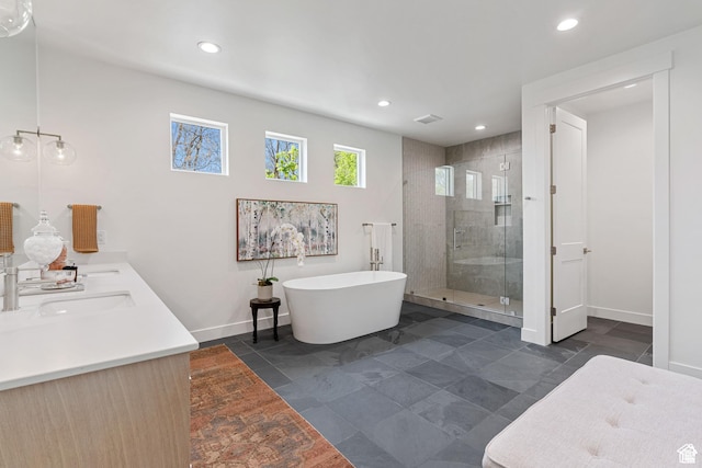 1782 E Bermondsey Ct, Holladay, UT 84117 - full bath featuring a shower stall, baseboards, a freestanding bath, double vanity, and recessed lighting