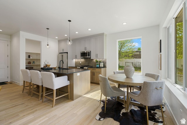 1782 E Bermondsey Ct, Holladay, UT 84117 - kitchen with appliances with stainless steel finishes, dark countertops, light wood-style flooring, and recessed lighting