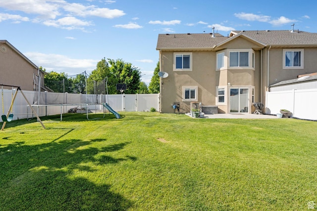 1099 W 200 S, Springville, UT 84663 - back of house featuring stucco siding, a trampoline, and a patio