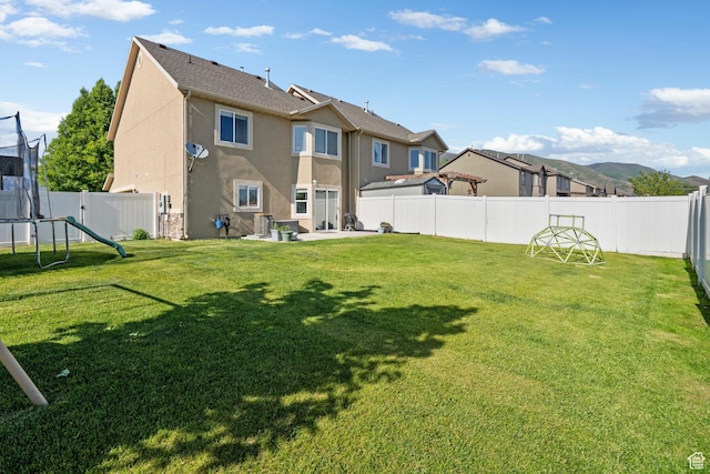 1099 W 200 S, Springville, UT 84663 - rear view of property featuring stucco siding, a trampoline, a patio, and a residential view