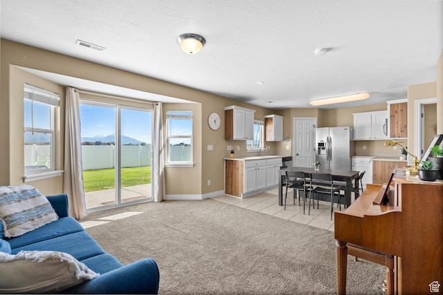 1099 W 200 S, Springville, UT 84663 - living room featuring light tile patterned floors, baseboards, and light colored carpet