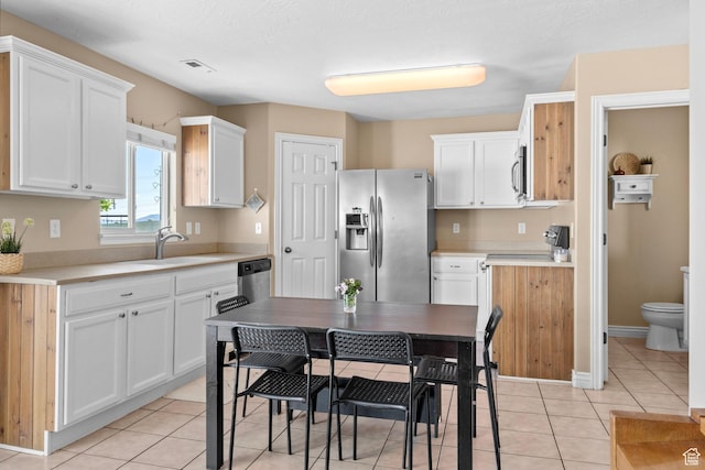 1099 W 200 S, Springville, UT 84663 - kitchen with appliances with stainless steel finishes, a sink, white cabinets, light countertops, and light tile patterned floors