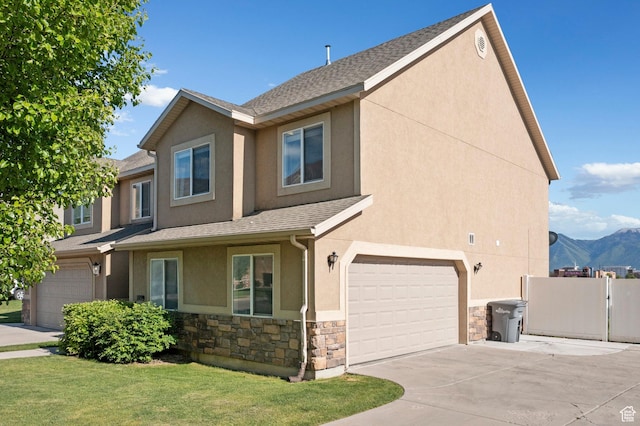 1099 W 200 S, Springville, UT 84663 - view of front of house with stucco siding, stone siding, an attached garage, driveway, and a shingled roof