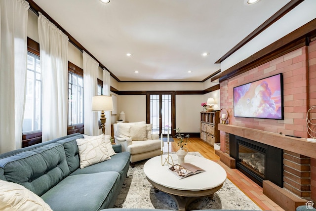 1376 E Perry Ave, Salt Lake City, UT 84103 - living area with crown molding, a large fireplace, recessed lighting, and light wood finished floors