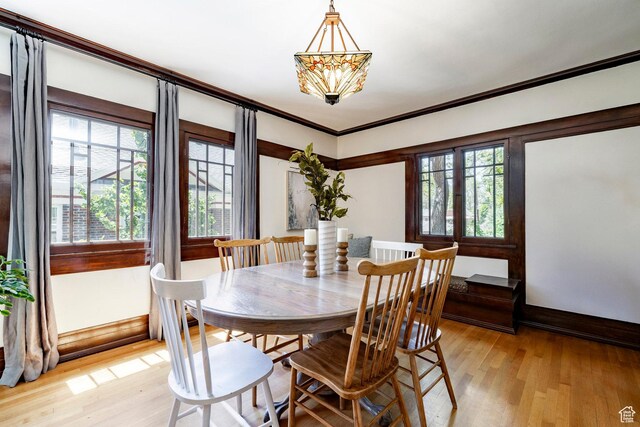 1376 E Perry Ave, Salt Lake City, UT 84103 - dining area with light wood finished floors, crown molding, and a chandelier