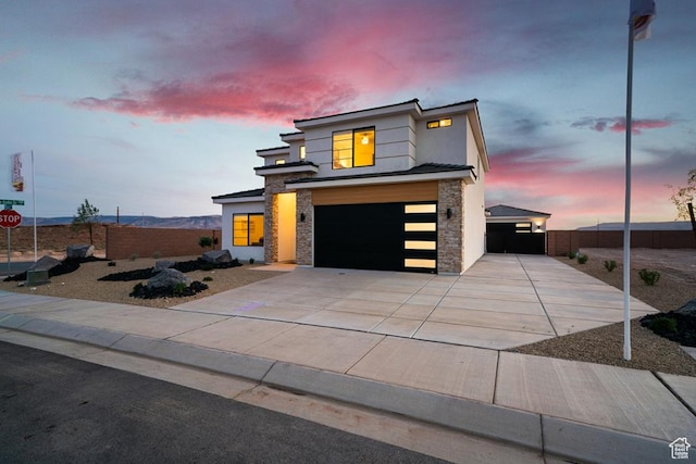 6068 S White Trails Dr, St George, UT 84790 - contemporary house with stone siding, a garage, driveway, and stucco siding