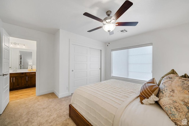 6068 S White Trails Dr, St George, UT 84790 - bedroom with light carpet, a closet, baseboards, ceiling fan, and connected bathroom