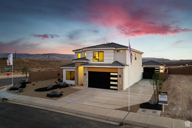 6068 S White Trails Dr, St George, UT 84790 - view of front of property featuring a garage, driveway, stucco siding, and a mountain view