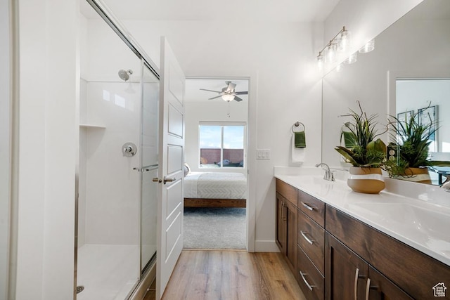 6068 S White Trails Dr, St George, UT 84790 - ensuite bathroom with wood finished floors, double vanity, a shower stall, ceiling fan, and baseboards