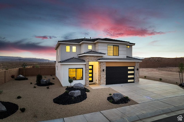 6068 S White Trails Dr, St George, UT 84790 - view of front of property featuring stone siding, an attached garage, driveway, and stucco siding